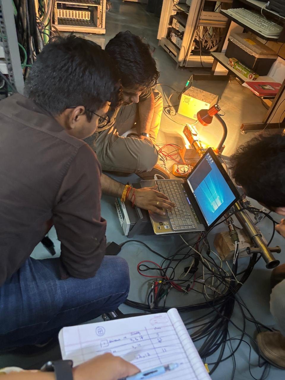 Students at laptops recording measurements during a night shift on the beamline