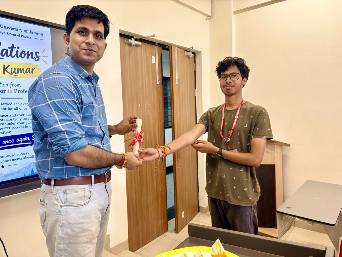 A research student handing over a congratulatory scroll